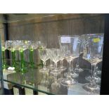 A set of ten green stemmed etched wine glasses, possibly German, and ten other wine glasses