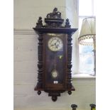 A 19th century walnut Vienna type wall clock, the mask and turned pediment surmounted by a horse,