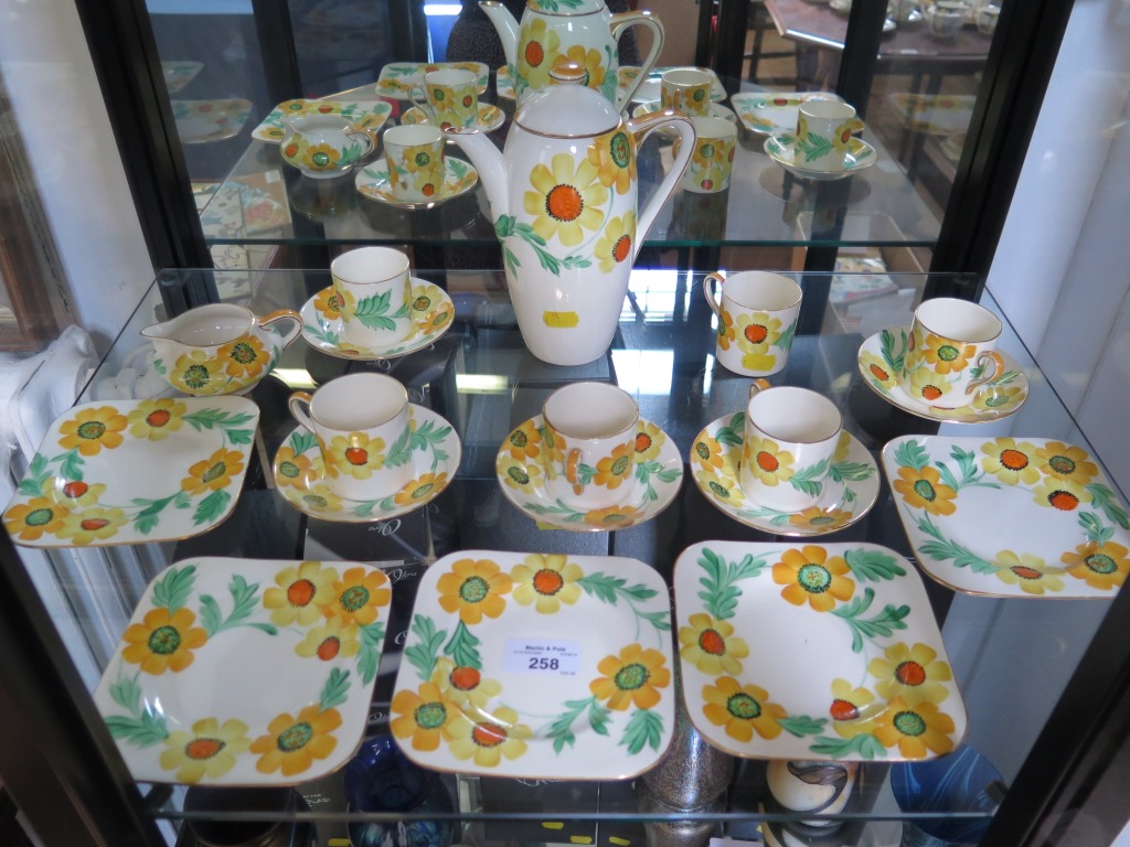 A Gray's Pottery coffee service, with yellow floral decoration comprising five cups and saucers,