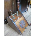 An Edwardian walnut coal box with carved panelled front and brass handle, a copper warming pan and a