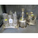 An eight bottle cruet on plated stand, a plated biscuit barrel on stand, and a single candlestick