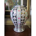 A Japanese baluster vase with underglaze blue bands and pink floral decoration, unmarked (cracked)