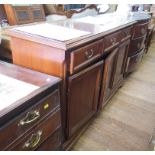 A mahogany side cabinet with three short drawers over three panelled doors on bracket feet, 142cm