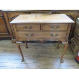 A George II style cherrywood lowboy with two short and one long drawers on cabriole legs with club