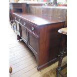 An Edwardian mahogany side cabinet, with two frieze drawers and three panelled doors, all with