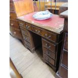 A reproduction mahogany kneehole desk, the leather inset top over two frieze drawers, above