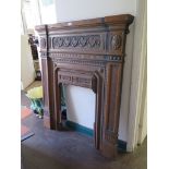 A late Victorian cast iron fire surround with swag and patera decoration, 108cm wide, 117cm high
