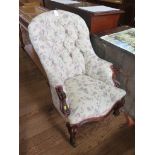 A Victorian mahogany buttonback armchair, with scroll end arms, moulded cabriole legs and brass