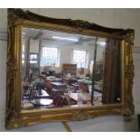 A giltwood framed rectangular wall mirror, with cabochon and scroll frame, 92.5cm x 67cm