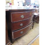 A Victorian crossbanded mahogany bowfront chest of drawers with two short and two long drawers on