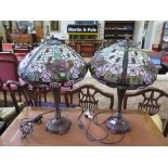 A pair of Tiffany style lead and opaque glass shaded table lamps, on bronze effect base, the