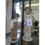 Two Nao by Lladro figures of a Shepherd boy carrying a lamb on his shoulder and a young boy carrying