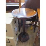 An early 19th centry rosewood occasional table, the circular top over a tapering octagonal stem