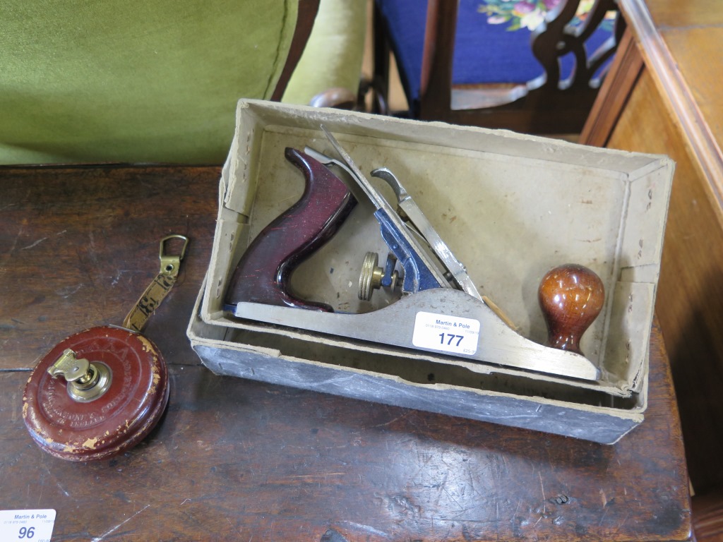 A John Rabone & Sons fabric and leather tape measure, 33 feet, no. 2601 and a Woden W4 smooth plane,