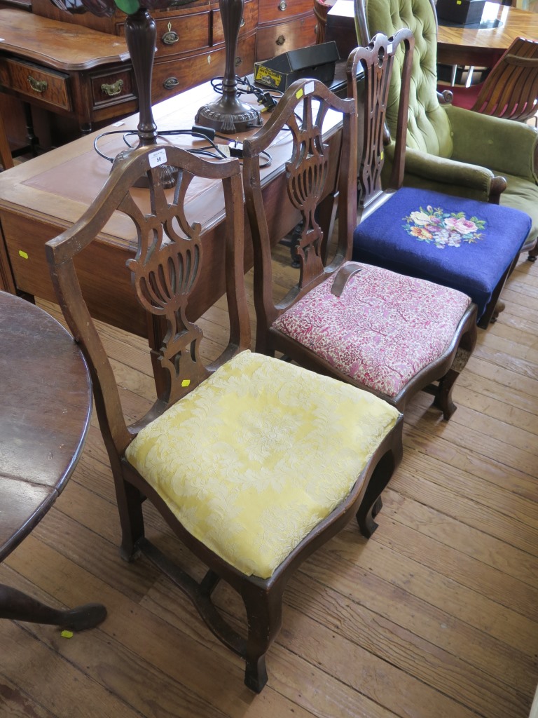 A pair of 19th century mahogany chairs, with pierced fret carved splats and cabriole legs joined
