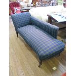 An Edwardian tartan covered chaise lounge on ring turned legs with later castors 180cm wide