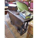 An 18th century oak gateleg table, the oval top over a frieze drawer on turned and block legs and