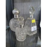 Two cut glass scent bottles with silver collars, Birmingham 1929 and London 1922 and a silver top