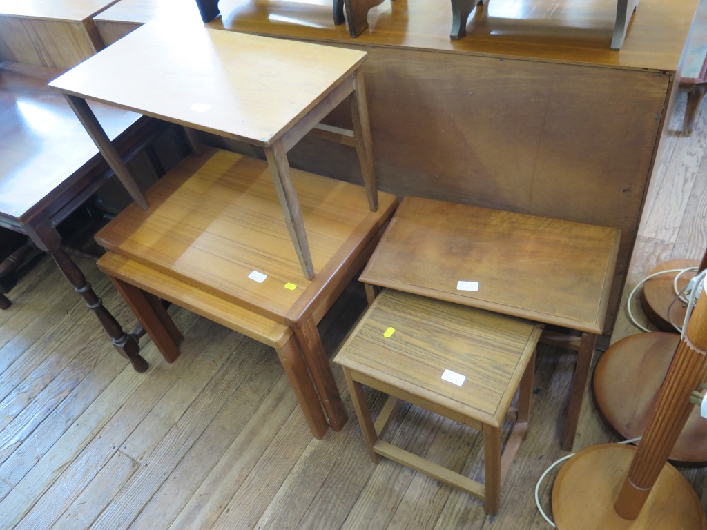 Three 1960s teak standard lamps, a Lloyd Loom corner basket, and seven various teak tables (11)