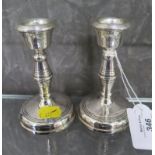 A pair of silver candlesticks 11cm high