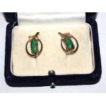 A boxed pair of jade earrings set in 14 carat gold