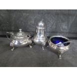 A three piece silver cruet with spoons and liners