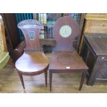 A Regency mahogany hall chair, with foliate carved waisted back, painted with a star crest on turned