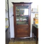 An Edwardian chevron banded mahogany display cabinet, the protruding cornice over a glazed door