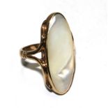 A 9 carat gold ring set with a large mother of pearl stone