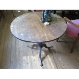 A George III oak snaptop tripod table, the circular top over a birdcage hinge on a baluster stem and