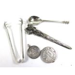 A small collection of silver items to include a French coin with a pair of scissors within the coin,