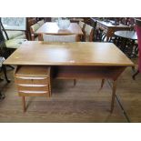 A Danish teak desk, designed by Gunnar Nielsen Tibergaard with three drawers and shelf to the