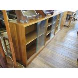 A 1950s oak plywood bookcase cabinet, with twin sliding glass doors and a pair of cupboard doors,