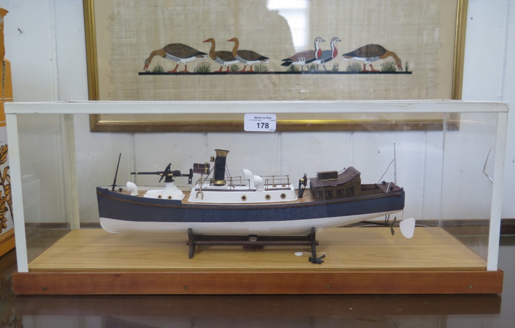 A scale model of a Naval patrol vessel, in a perspex case, 45cm long