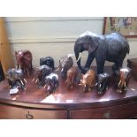 A collection of hardwood model elephants and a large leather covered model similar, 36cm high (11)