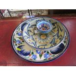 A decorative wall charger 32cm diameter, a bowl and two other small bowls all with hand decorated