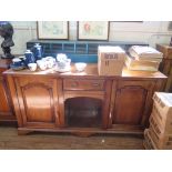 A George II style cherrywood dresser base, with central drawer and open compartment flanked by