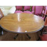 A mid Victorian inlaid walnut tilt top breakfast table, the oval top on five turned supports and