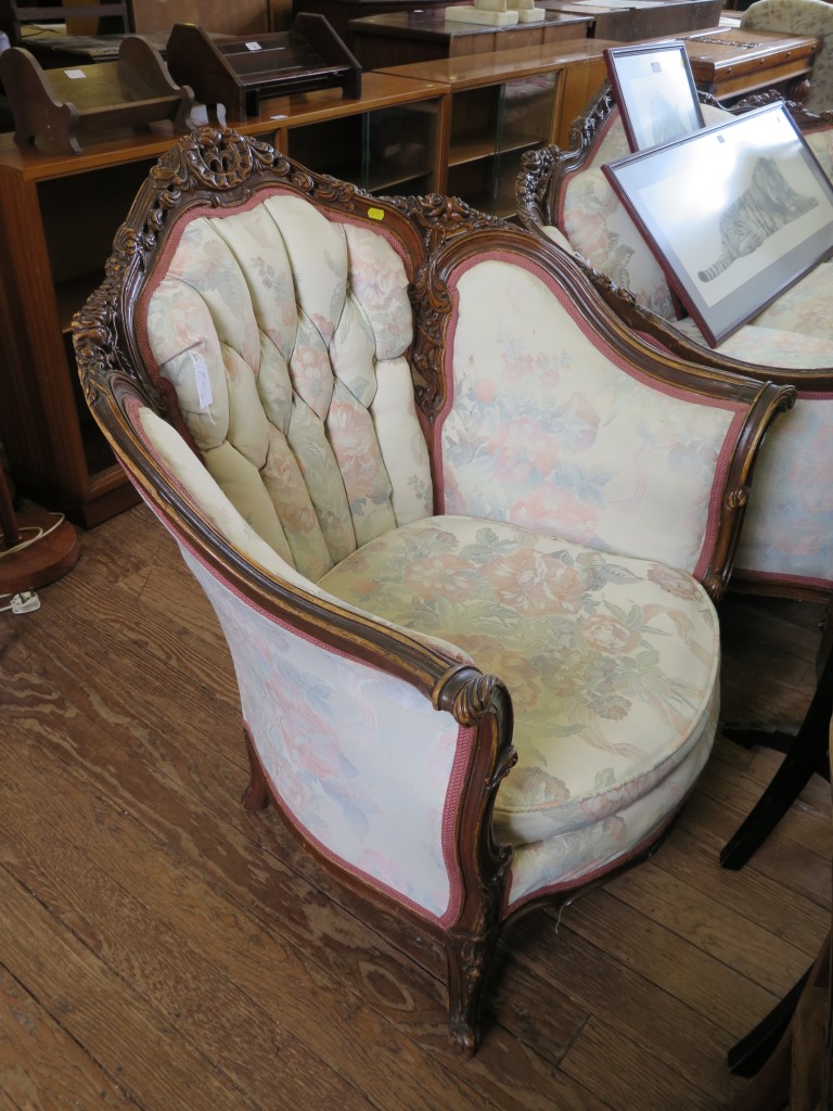 A French style three seat button back settee, with floral carving and cabriole legs, 195cm wide, and