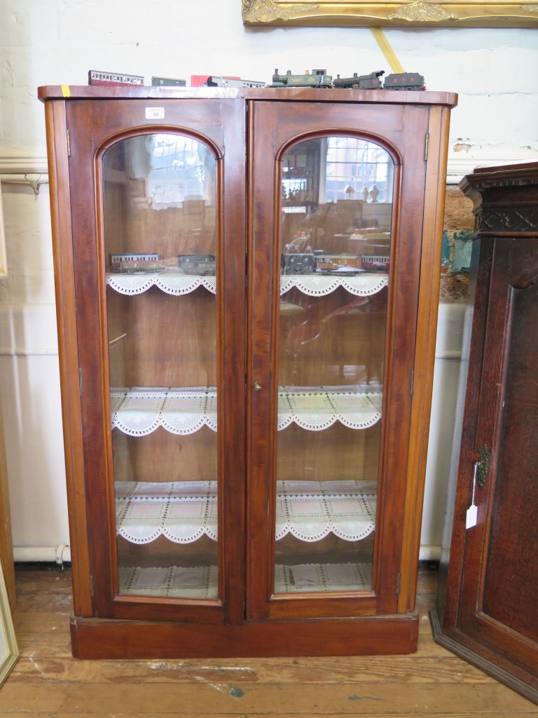 A Victorian mahogany bookcase, with twin glazed doors and adjustable shelves on a later plinth base,