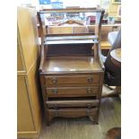 An early 20th century mahogany music cabinet, with two open shelves over four fall front drawers