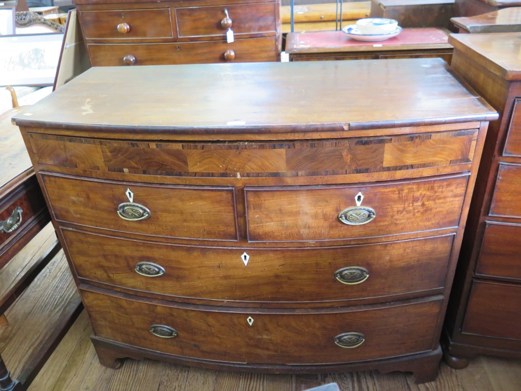 An early Victorian mahogany bowfront chest of drawers, with crossbanded frieze drawer over two short