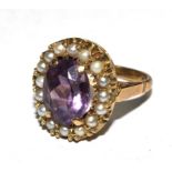 A 9 carat gold cluster ring of seed pearls and centre amethyst