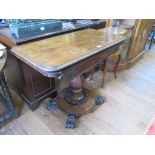 An early Victorian rosewood foldover card table, the rectangular top enclosing a circular playing