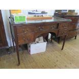 A mahogany dressing table, the central drawer flanked by two drawers on either side on square legs