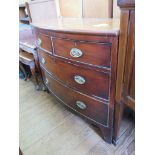 An early 19th century mahogany bowfront chest of drawers, with two short and two long graduated