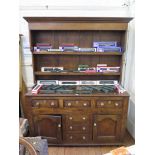 A 19th century oak dresser and rack, the cavetto moulded top over two shelves above a base with