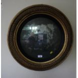 A Regency giltwood convex mirror with diaper pattern cushion moulded frame, 58cm diameter