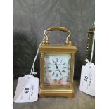 A brass miniature carriage clock by Elliott & Son, London, with enamel panels depicting cherubs