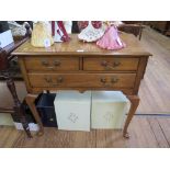 A George II style cherrywood lowboy with two short and one long drawers on cabriole legs with club